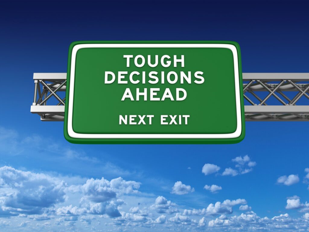 “Tough Decisions Ahead” signage