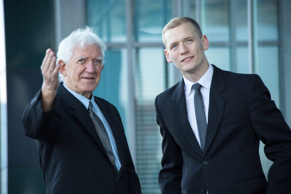 Two Corporate People Talking and Pointing Towards Something