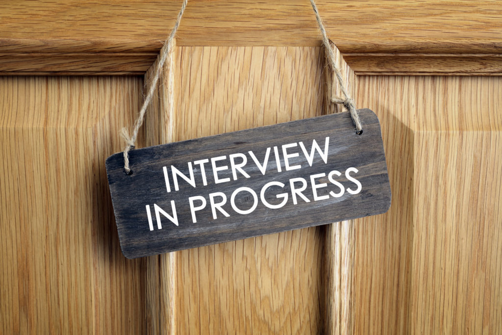 “Interview in Progress” signage